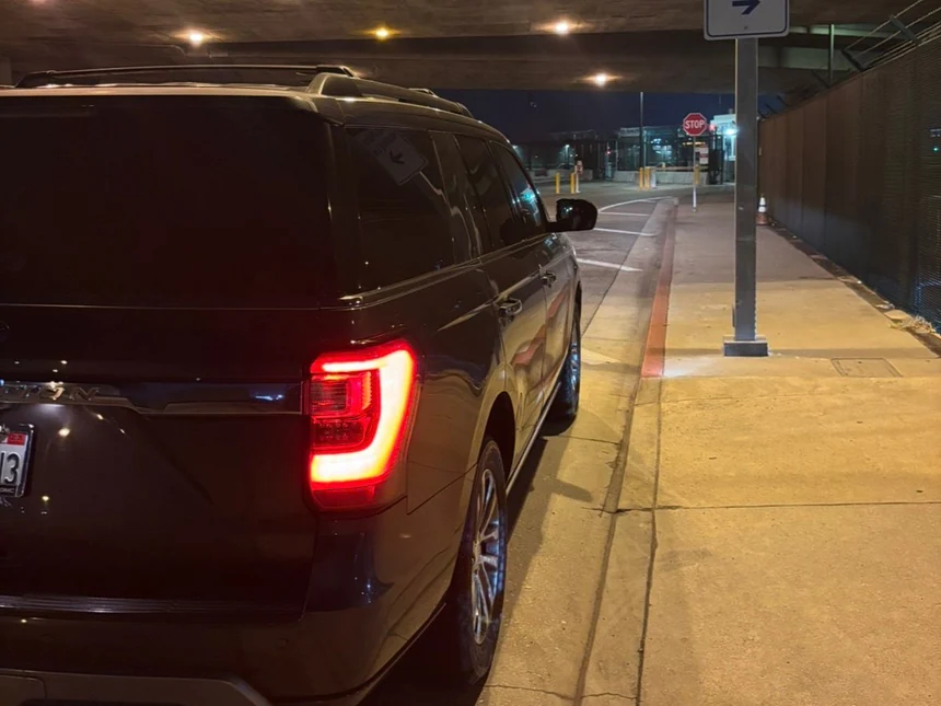 Luxury SUV waiting in the LAX cell phone lot at night for a late arrival